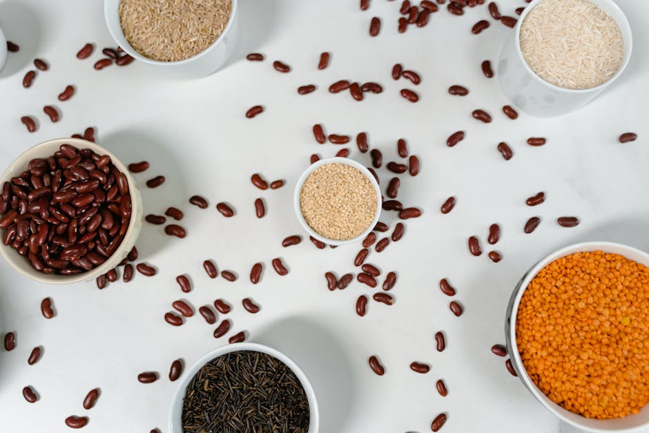 Quinoa, soy, beans, hemp seeds, lentils — protein-rich plant foods on a wooden table