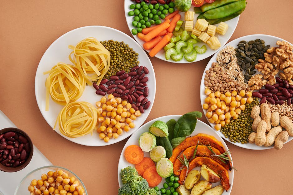 Balanced vegan plate with grains, legumes, and vegetables alongside a notebook