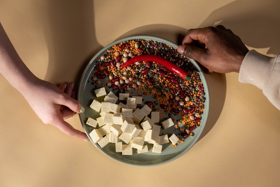 Iron-rich plant foods — lentils, tofu, pumpkin seeds, spinach — with citrus alongside