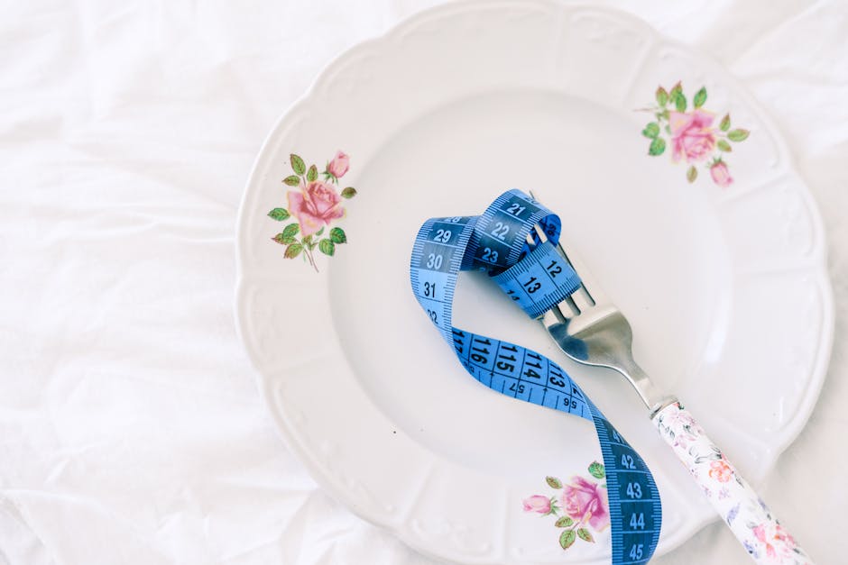 Plant-based plate with measured portions next to a notebook for tracking
