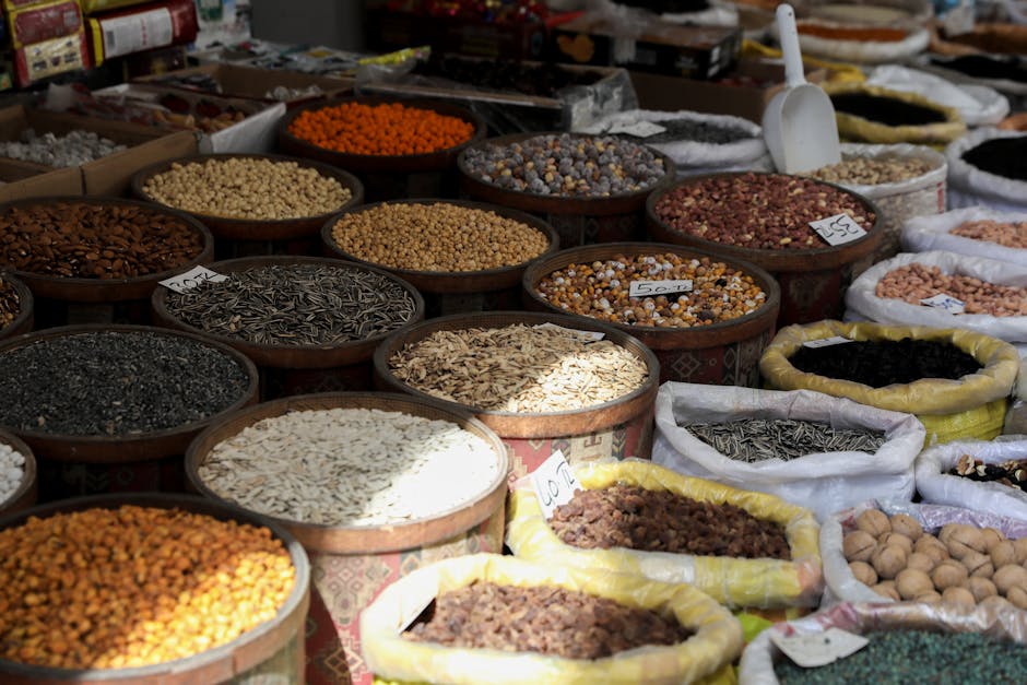 Pumpkin seeds, brazil nuts, dark leafy greens, lentils, and oats arranged on a board
